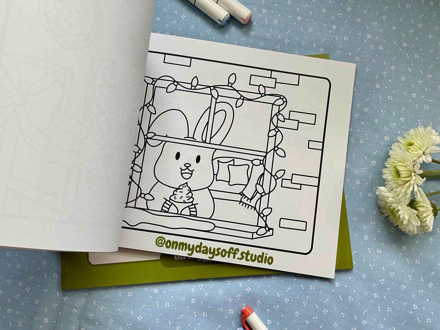 Juni and friends coloring book volume 4 is winter themed - Christmas lights around a window