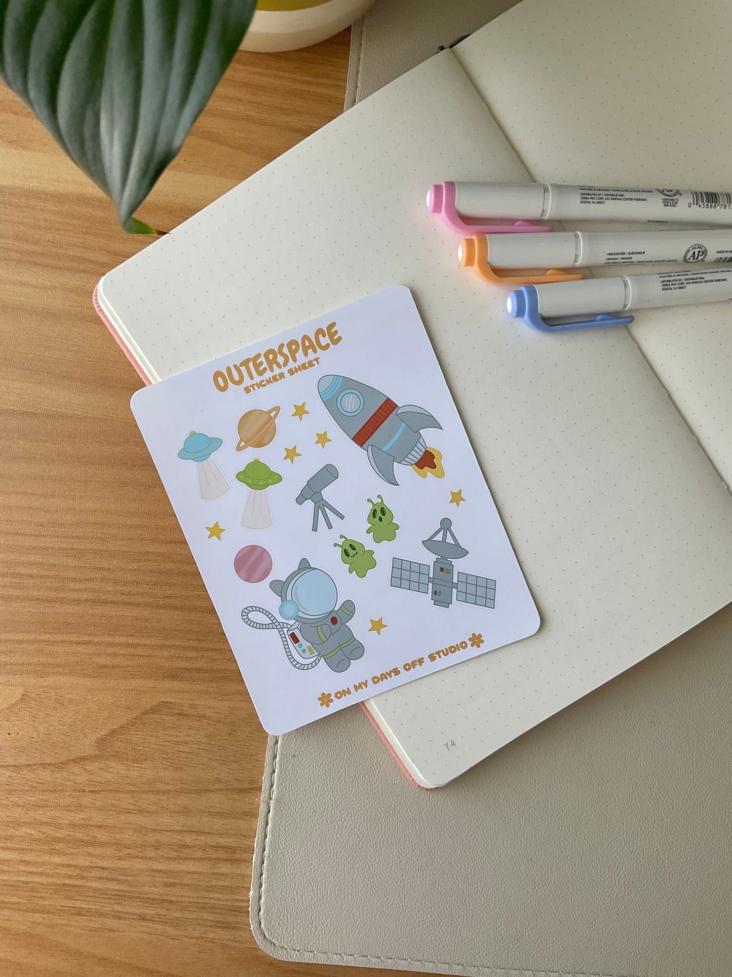 This stationery sticker sheet features a space theme and has 16 colorful illustrations, including a spaceship, cat astronaut, planets, stars, alien spaceship, and more. These glossy stickers are perfect for planners and bullet journals. 