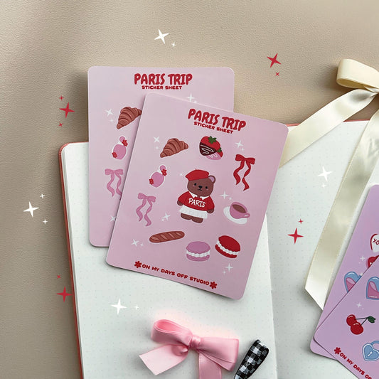 This stationery sticker sheet features a Paris Trip theme and has 10 colorful illustrations. This includes a bear in a Paris sweater, bows, chocolate dipped strawberries, croissant, perfume, macaroons and a french baguette. These glossy stickers are perfect for planners and bullet journals. 