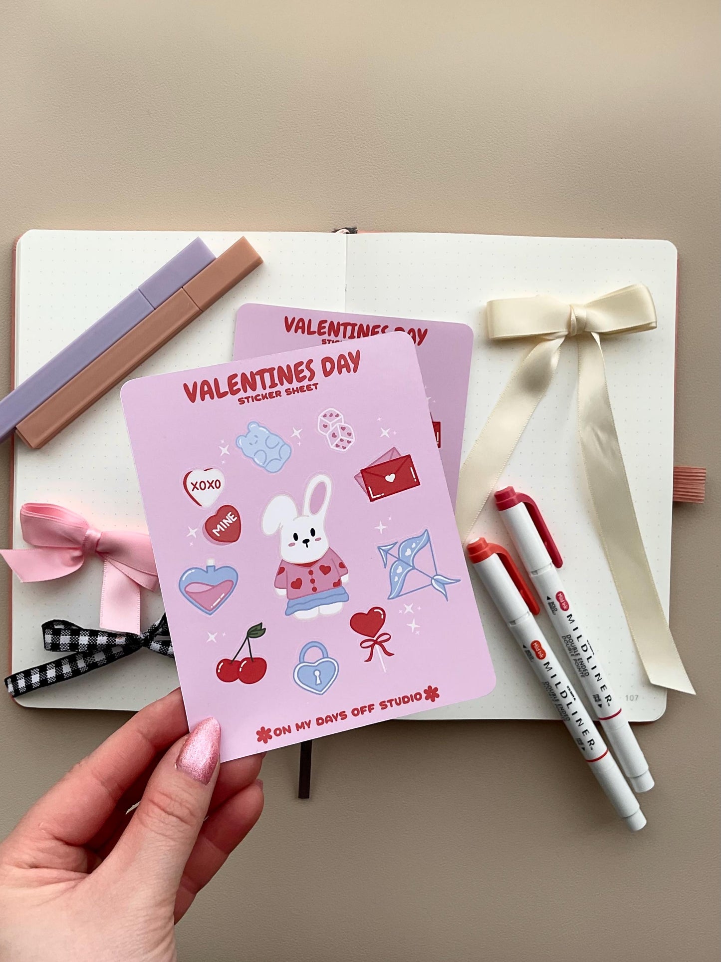 This stationery sticker sheet features a Valentine’s Day theme and has 11 colorful illustrations. These illustrations include a cute bunny in a valentine's outfit and heart themed items. These glossy stickers are perfect for planners and bullet journals.