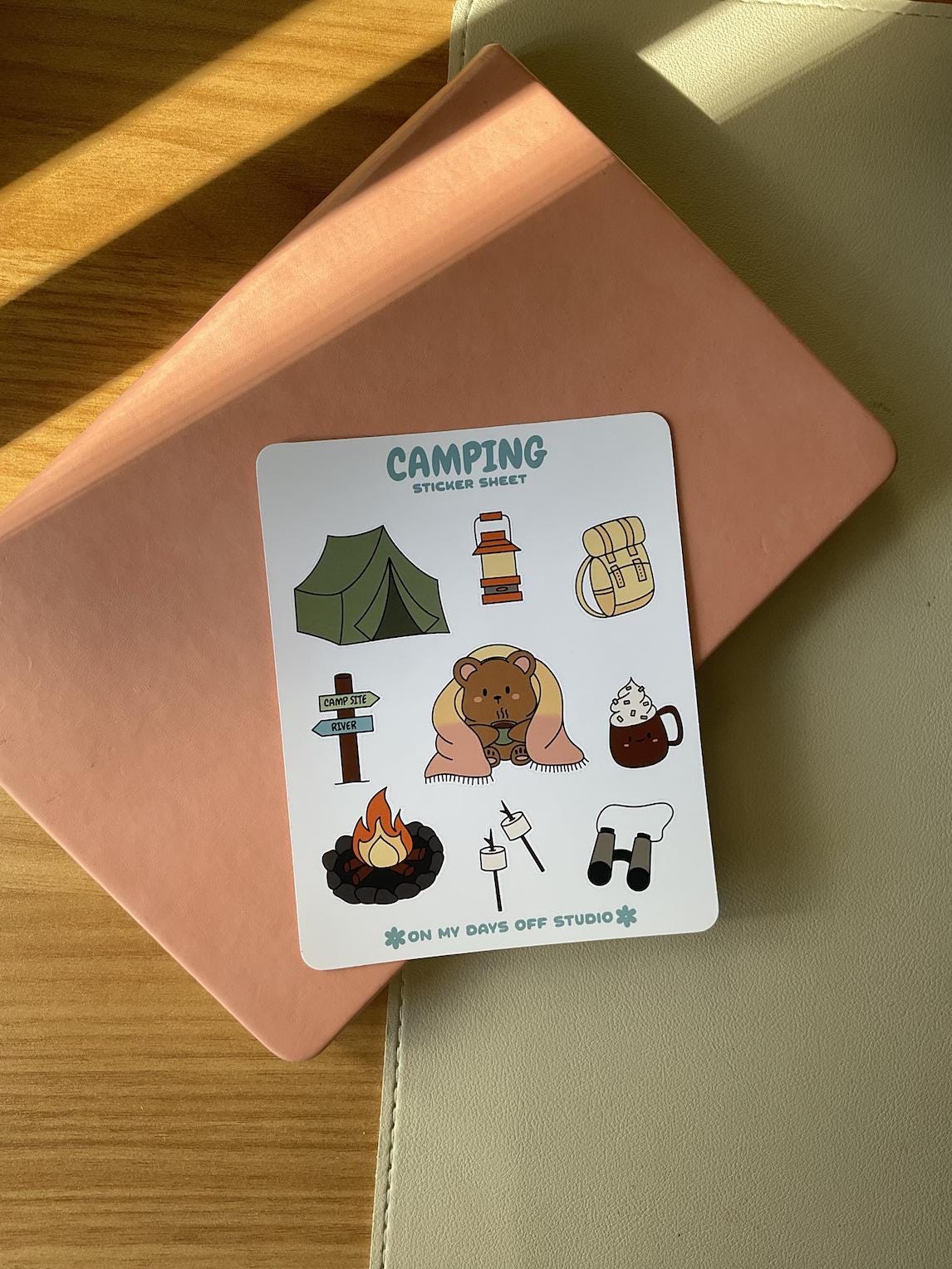 This stationery sticker sheet features a colorful camping theme and has 9 colorful illustrations, including a bear wrapped in a blanket, tent, backpack, fire pit, marshmallows and more. These glossy stickers are perfect for planners and bullet journals.&nbsp;