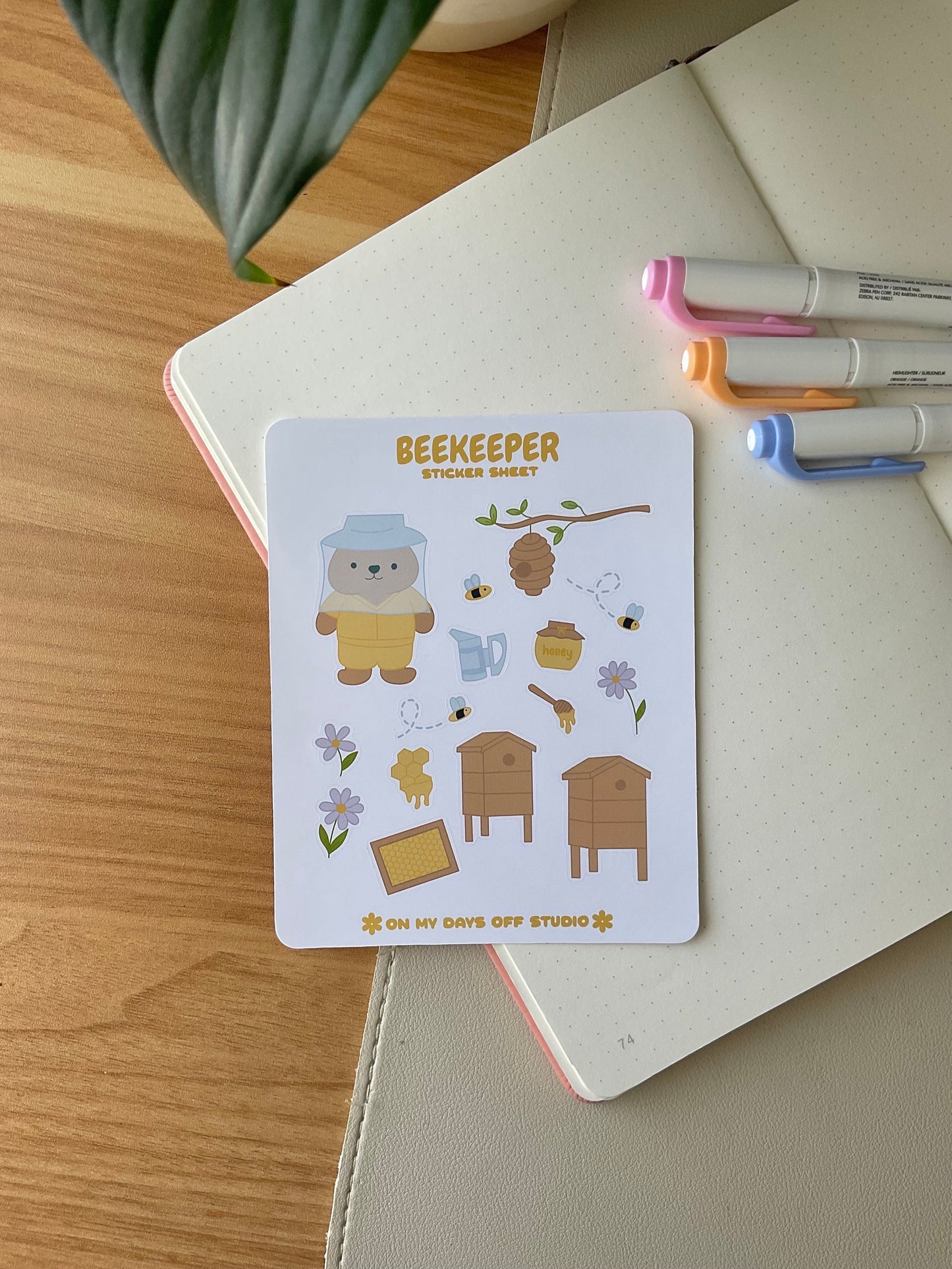 This stationery sticker sheet features a bee theme and has 15 colorful illustrations. These adorable illustrations includes a bear beekeeper, honey hives, bees, flowers and flowers. These glossy stickers are perfect for planners and bullet journals.