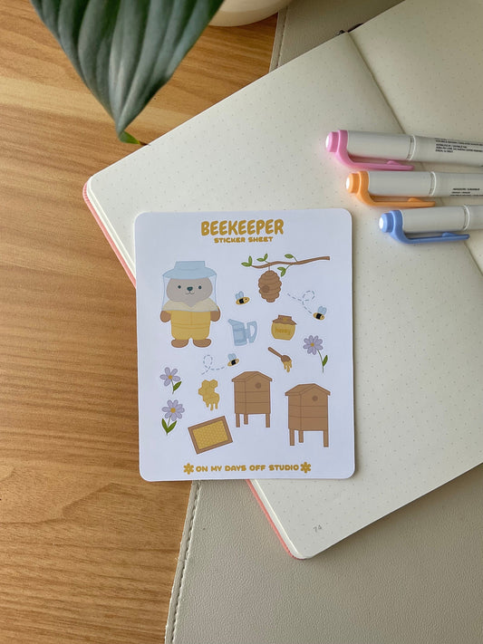 This stationery sticker sheet features a bee theme and has 15 colorful illustrations. These adorable illustrations includes a bear beekeeper, honey hives, bees, flowers and flowers. These glossy stickers are perfect for planners and bullet journals.