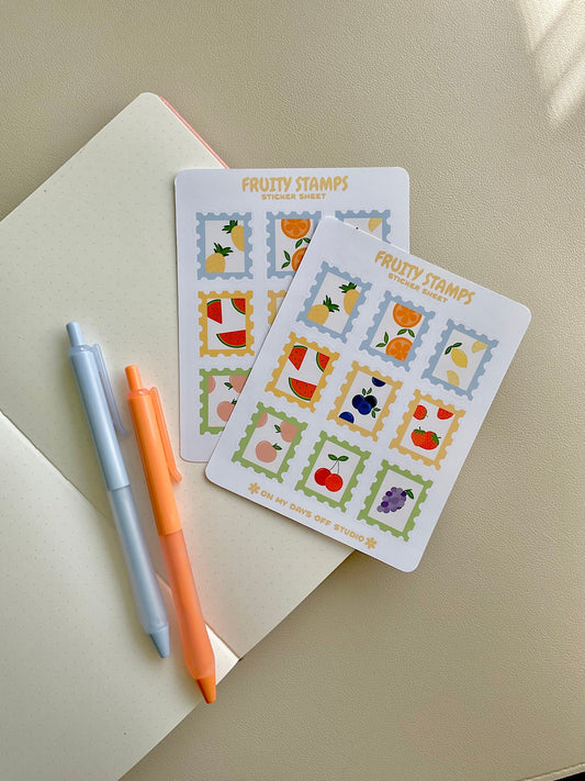 Fruit stamps sticker sheet features 9 glossy stickers with a variety of fruits such as pineapple, orange, lemon, watermelon, blueberry, strawberry, peach, cherry and grape. Featuring two sticker sheets layered.
