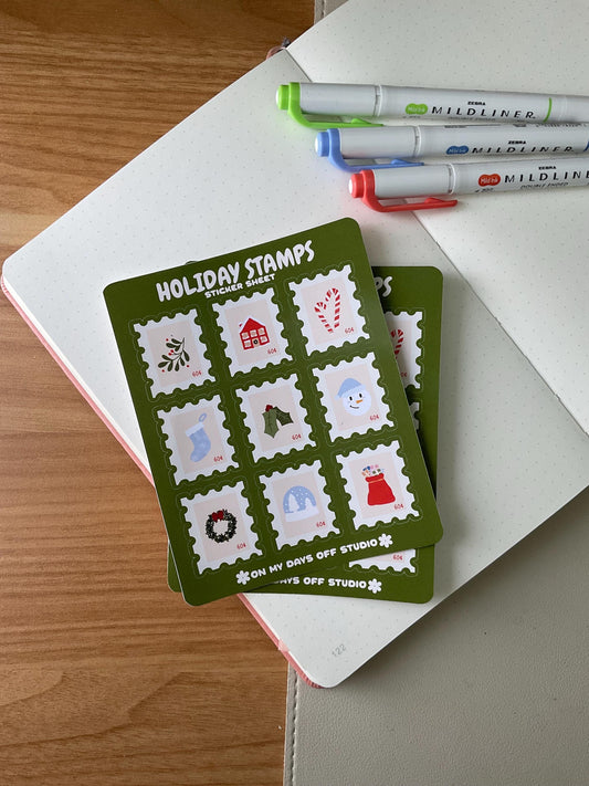 Holiday stamps sticker sheet featuring 9 cute stamps that include illustrations of mistletoe, stocking, candy cane, snow globe, and other holiday decorations.