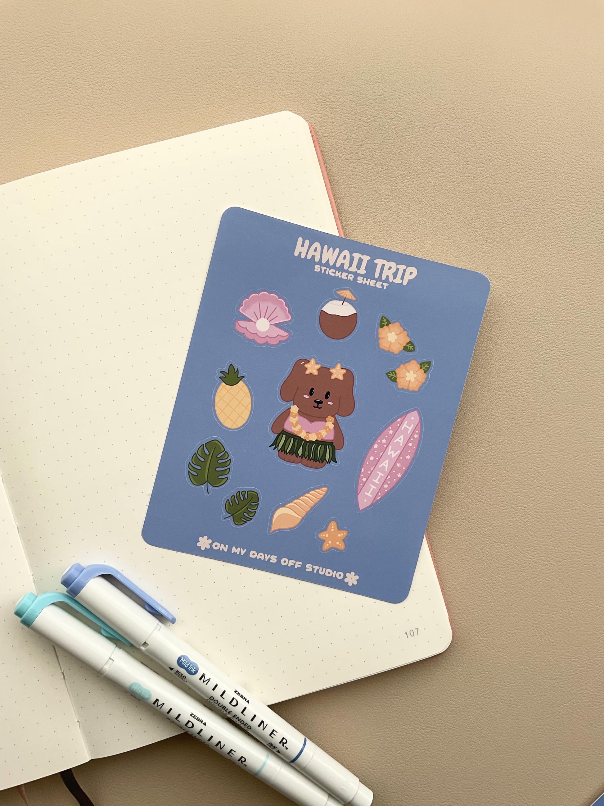 This stationery sticker sheet features a Hawaii Trip theme and has 11 colorful illustrations. This sticker sheet includes a dog in a grass skirt and other island items like a surf board, pineapple, coconut drink, and sea shells. These glossy stickers are perfect for planners and bullet journals.&nbsp;