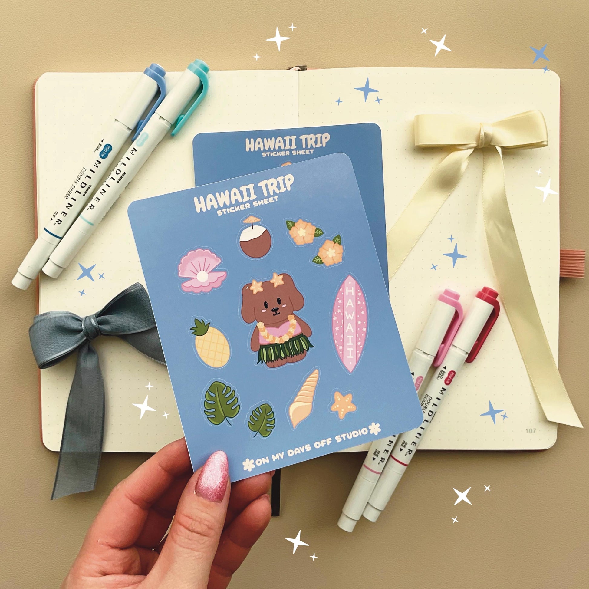 This stationery sticker sheet features a Hawaii Trip theme and has 11 colorful illustrations. This sticker sheet includes a dog in a grass skirt and other island items like a surf board, pineapple, coconut drink, and sea shells. These glossy stickers are perfect for planners and bullet journals.&nbsp;