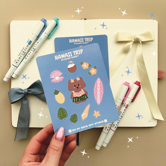 This stationery sticker sheet features a Hawaii Trip theme and has 11 colorful illustrations. This sticker sheet includes a dog in a grass skirt and other island items like a surf board, pineapple, coconut drink, and sea shells. These glossy stickers are perfect for planners and bullet journals.&nbsp;
