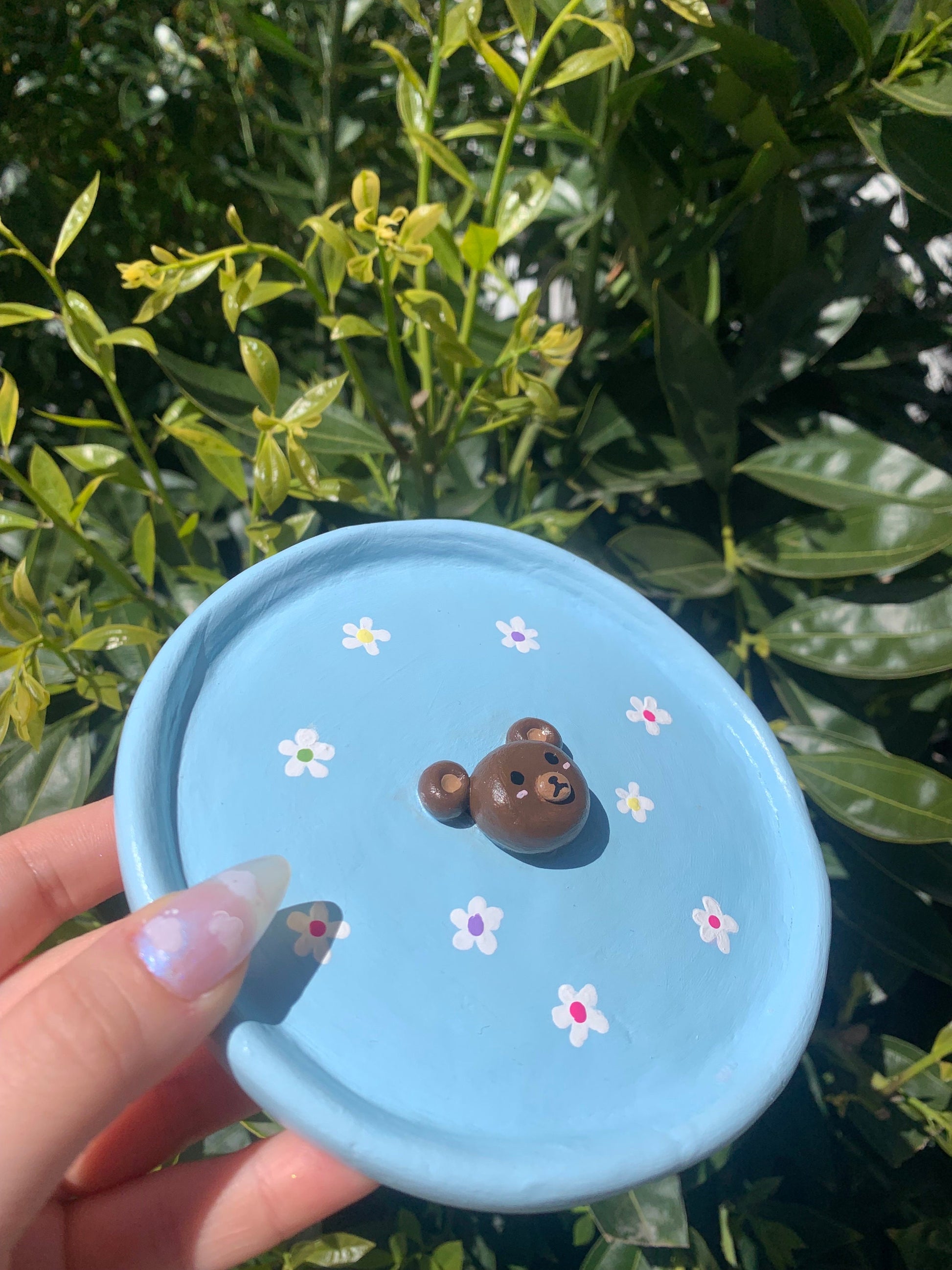 This cute tray can be used to hold your jewelry, a catch all dish or even just a decor piece. Features a 3D bear in the center and hand painted flowers.