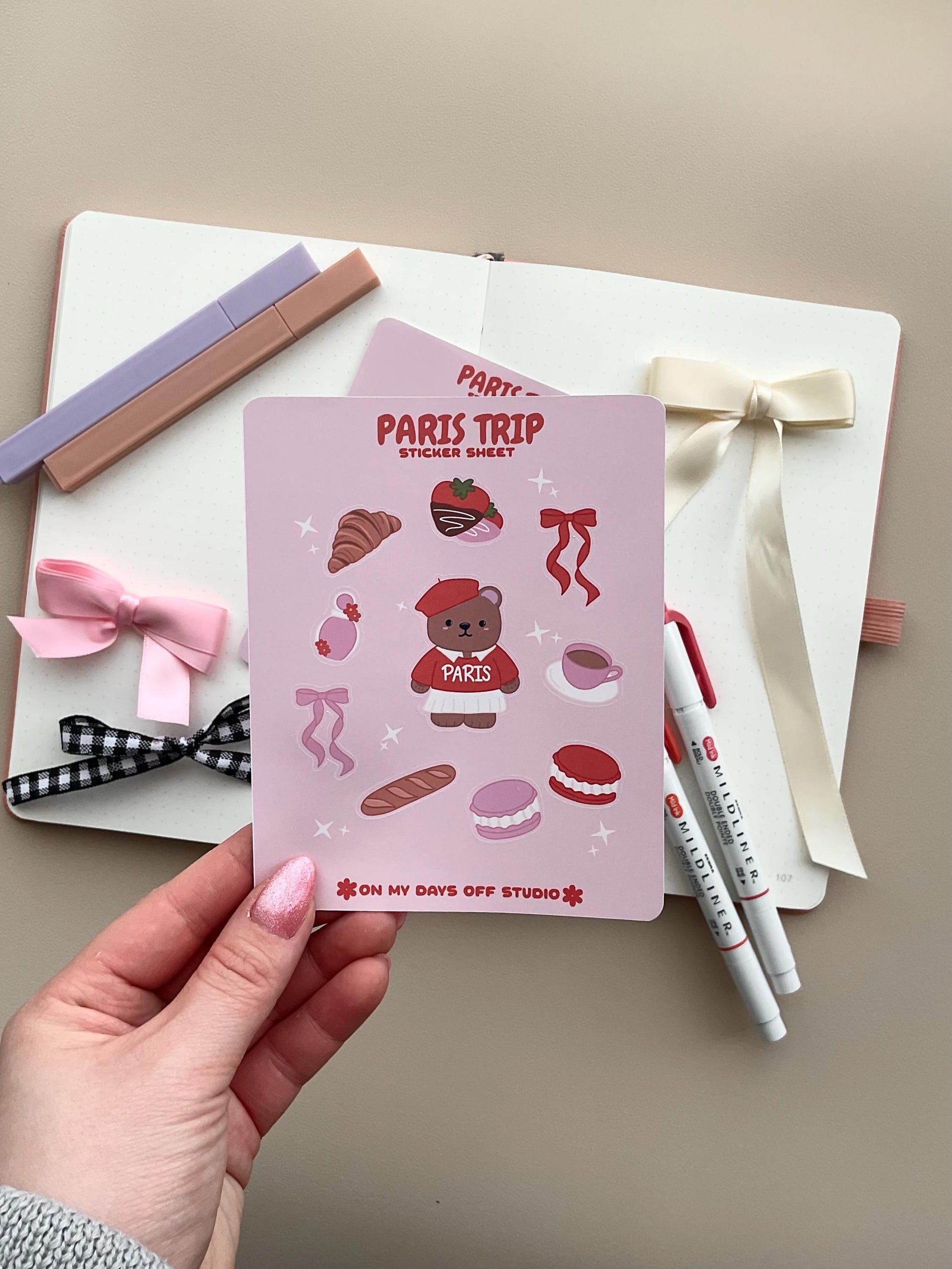 This stationery sticker sheet features a Paris Trip theme and has 10 colorful illustrations. This includes a bear in a Paris sweater, bows, chocolate dipped strawberries, croissant, perfume, macaroons and a french baguette. These glossy stickers are perfect for planners and bullet journals.&nbsp;