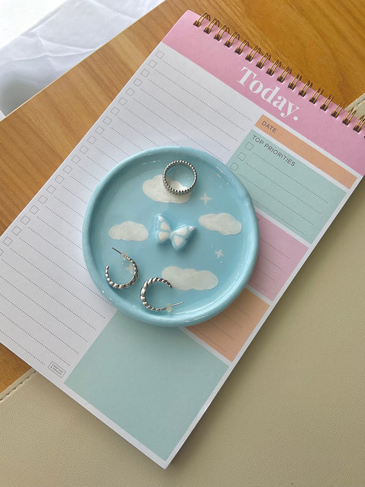 Dreamy handmade clay jewelry dish with clouds painted on and a 3D butterfly in the center. 