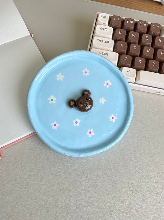 This cute tray can be used to hold your jewelry, a catch all dish or even just a decor piece. Features a 3D bear in the center and hand painted flowers.