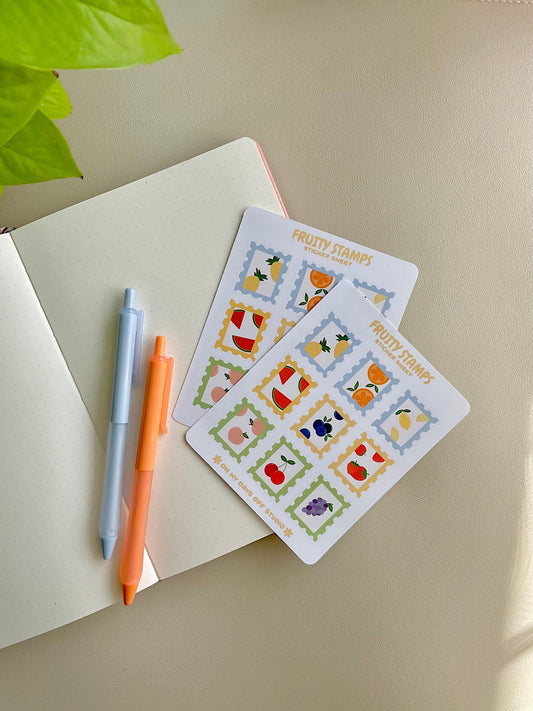 Fruit stamps sticker sheet features 9 glossy stickers with a variety of fruits such as pineapple, orange, lemon, watermelon, blueberry, strawberry, peach, cherry and grape. 